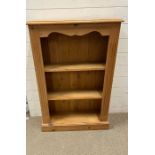 A pine shelving unit with scrolling top (H104cm W68cm D22cm)