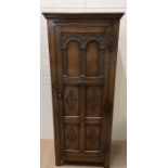 An oak hall cupboard carved panelled front (H182cm W76cm D49cm)