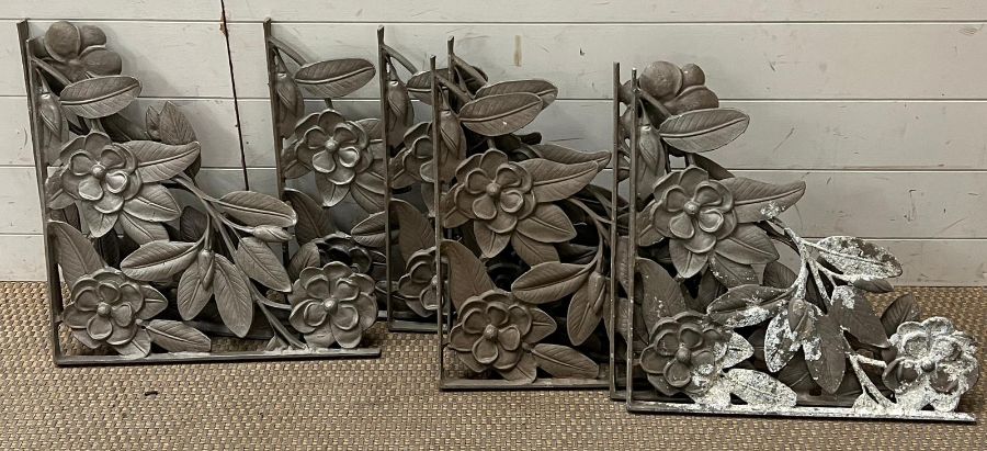 A set of eight cast iron wall brackets with floral theme