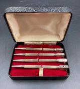 A set of four sterling silver bridge pencils, boxed