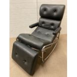 A black leatherette rocking chair with leg cushion in the style of Lama