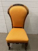 A Victorian Carved walnut chair with orange upholstery
