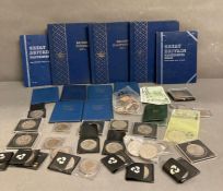 A selection of United Kingdom collectors coin packs including British Pennies, first decimal