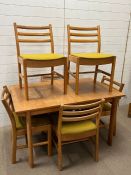 A mid Century dining table with six ladder back chairs (H73cm W130cm D84cm)