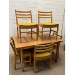 A mid Century dining table with six ladder back chairs (H73cm W130cm D84cm)