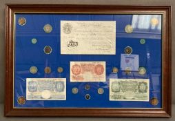 A framed selection of bank of England currency to include ten shillings, one pound notes and a