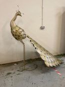 A large ornamental metal peacock in gold height 165 cm length from head to tail 220 cm