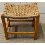 A vintage stool with a webbing seat
