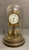 A brass glass domed 400 day clock