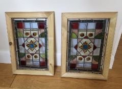 Two reclaimed stained glass window panels, framed 43xm x 29cm
