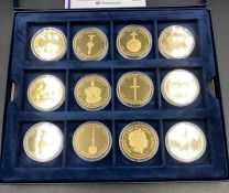 A selection of twelve Westminster Mint collectable coins from The Crown Jewels Coin Collection