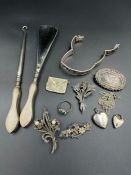 A small selection of silver jewellery and other silver items.