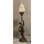 An Art Deco style table lamp of a lady holding a torch
