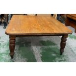 Light oak square dining table with fluted baluster turned tapering legs and china castors (H75cm