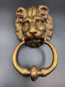 A brass lion shaped door knocker