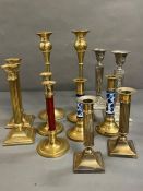 A large selection of brass and white metal candlesticks