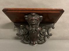 A hand carved Gothic oak wall sconce with shelf