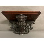 A hand carved Gothic oak wall sconce with shelf