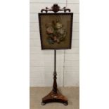 A Victorian pole screen with a framed floral theme embroidery