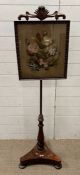A Victorian pole screen with a framed floral theme embroidery
