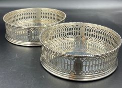 A pair of hallmarked silver wine coasters with pierced decoration, hallmarked for London 1773 by