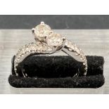 A 1.5ct diamond ring with diamond shoulders, set in 14ct white gold Size L