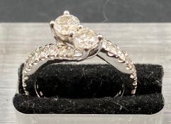 A 1.5ct diamond ring with diamond shoulders, set in 14ct white gold Size L