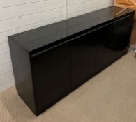 A black lacquer sideboard, four doors opening to adjustable shelfs and drawers (H76cm W180cm D40cm)