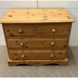 A pine chest of drawers, two over two (H62cm W75cm D41cm)
