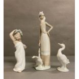 A selection of three lladro figures. A goose, a young girl dancing and lady tending her geese AF