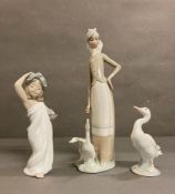 A selection of three lladro figures. A goose, a young girl dancing and lady tending her geese AF
