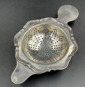 A silver tea strainer, hallmarked for Sheffield 1924 by Atkin Brothers