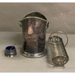 Three silver plate items. A wine cooler, mustard and a biscuit rack