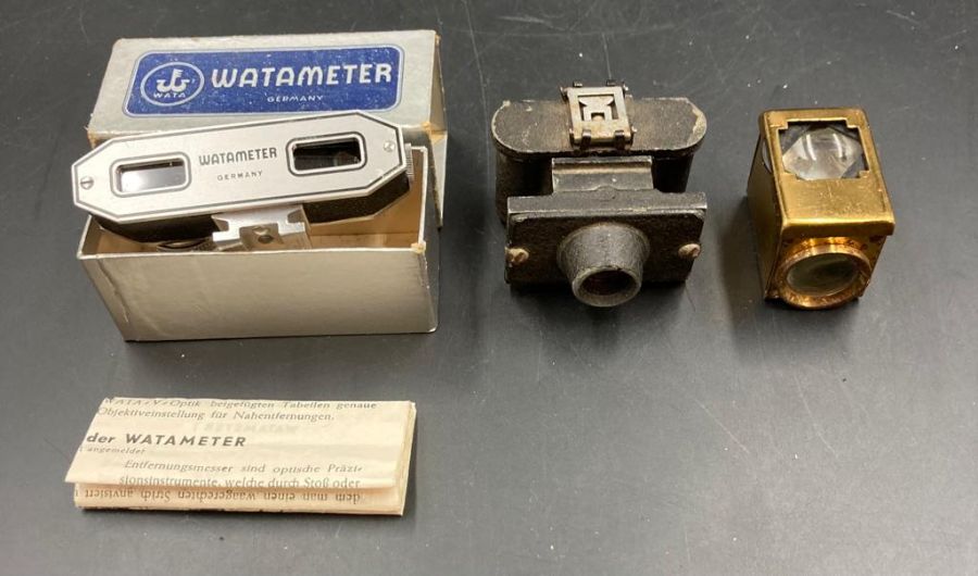 A Watameter range finder in box and a miniature camera and lens