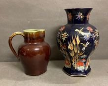 Two ceramic items. A Denby stoneware jug in green and brown and and an etched cobalt blue vase