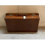 A vintage leather suitcase with keys