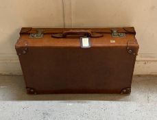 A vintage leather suitcase with keys