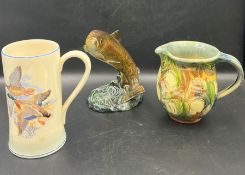 A Beswick trout along with two pottery jugs