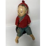 A rare Chinese doll of a boy dressed in traditional clothes