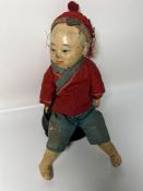 A rare Chinese doll of a boy dressed in traditional clothes