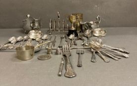 A selection of silver plated and white metal items to include sauce boats, cutlery, toast rack etc.