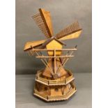 A decorative wooden model of a windmill