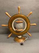 A Mid Century desk lamp in the shape of a ship wheel