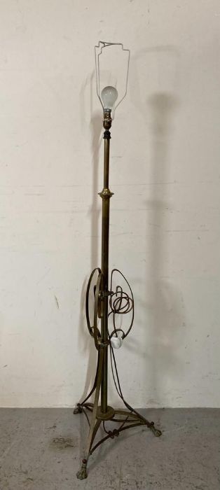 A brass floor standing lamp on lion paw feet