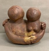 A Studio Pottery sculpture of a couple embracing