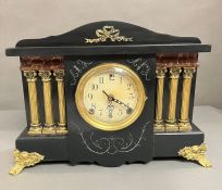 A faux wooden mantel clock