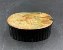 A papier Mache snuff box with a hand painted church scene to lid