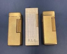 Three lighters including two Dunhill lighters in gold metal