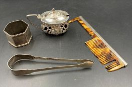 A small selection of silver items to include napkin ring, sugar tongs, comb Af and an ornate mustard