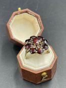 A 9ct gold and garnet daisy style ring Size Q